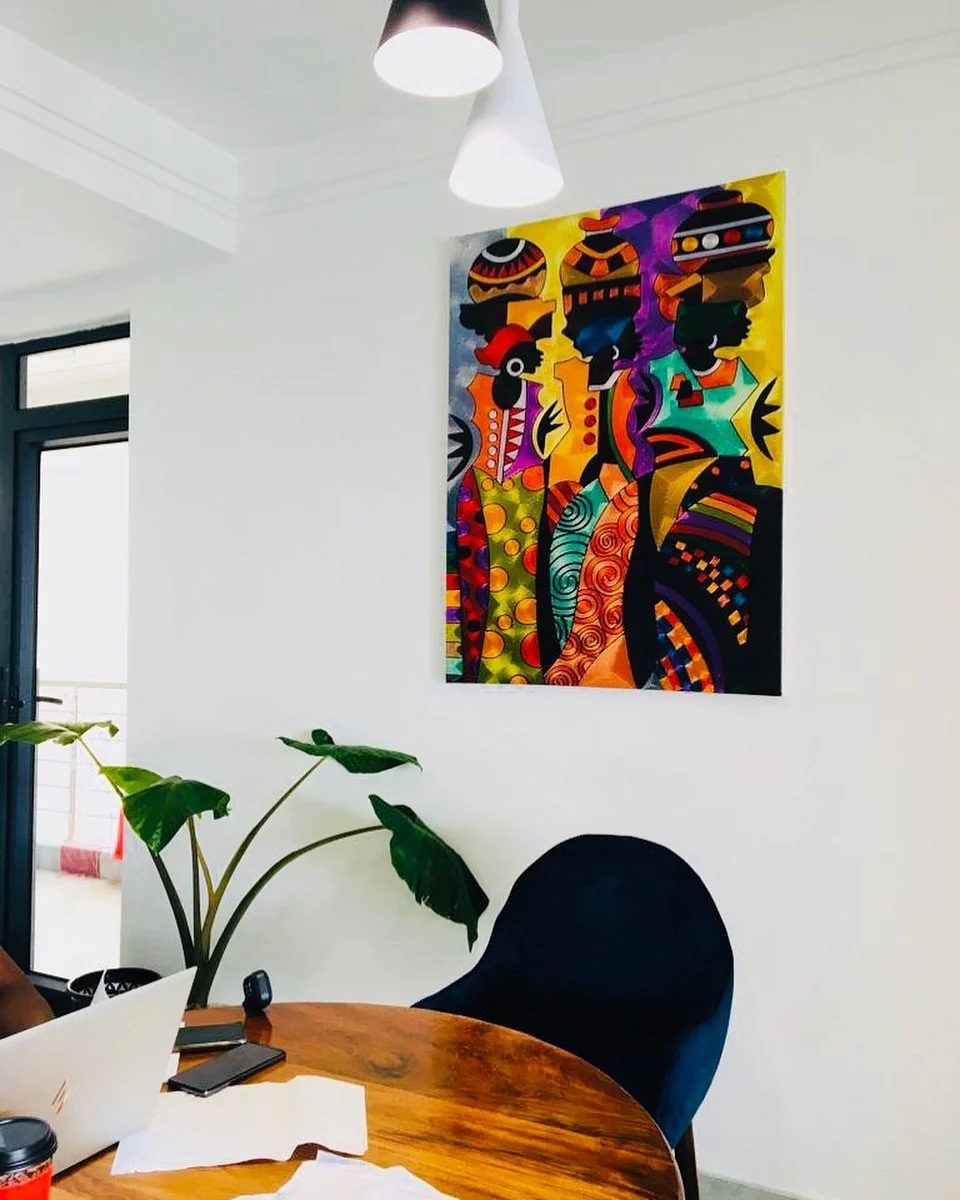 A colourful portrait beside a dining area