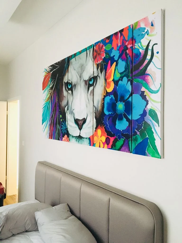 Colourful lion portrait above an upholstered headboard