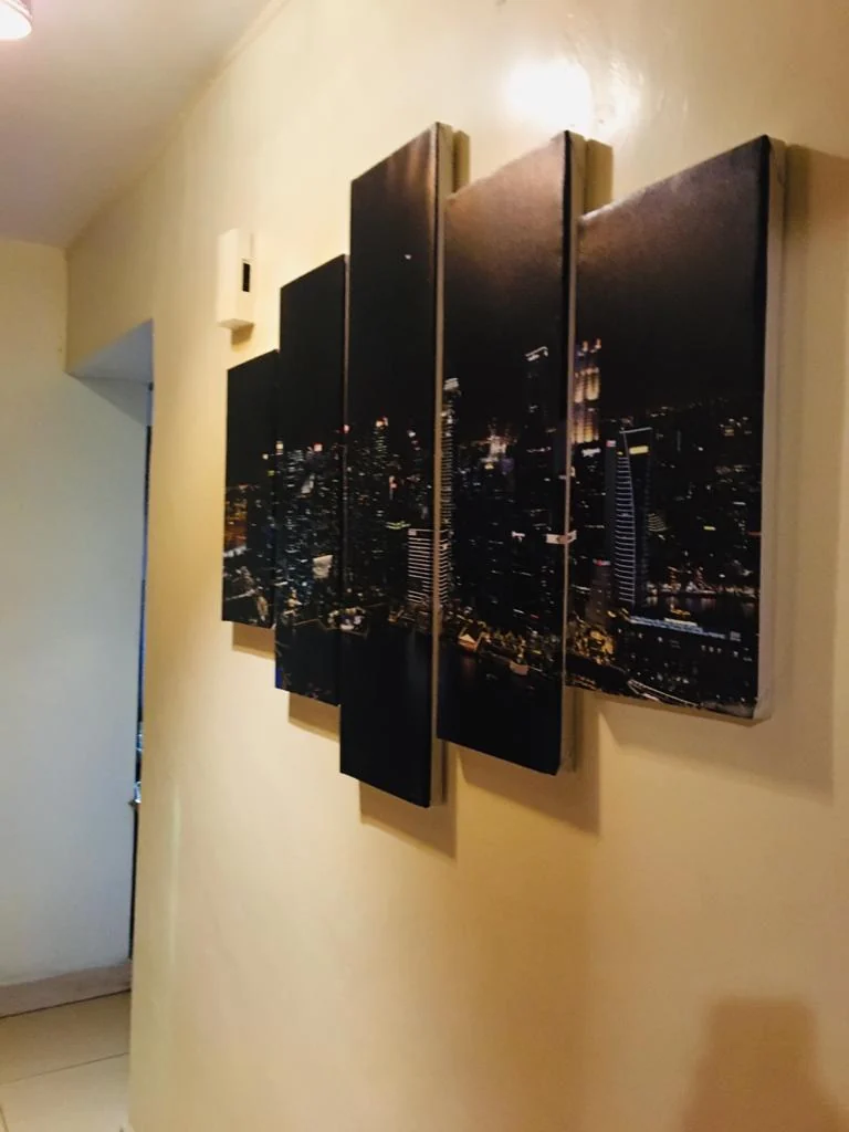Multi-panel city artwork mounted along a corridor